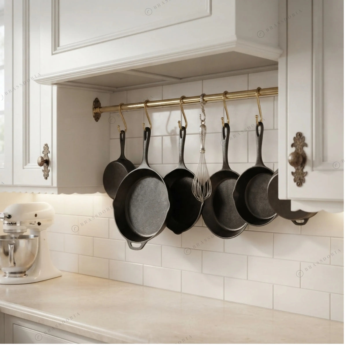 Pot rail with S-hooks in a brass finish, shown with cast iron pans – Brassdoria